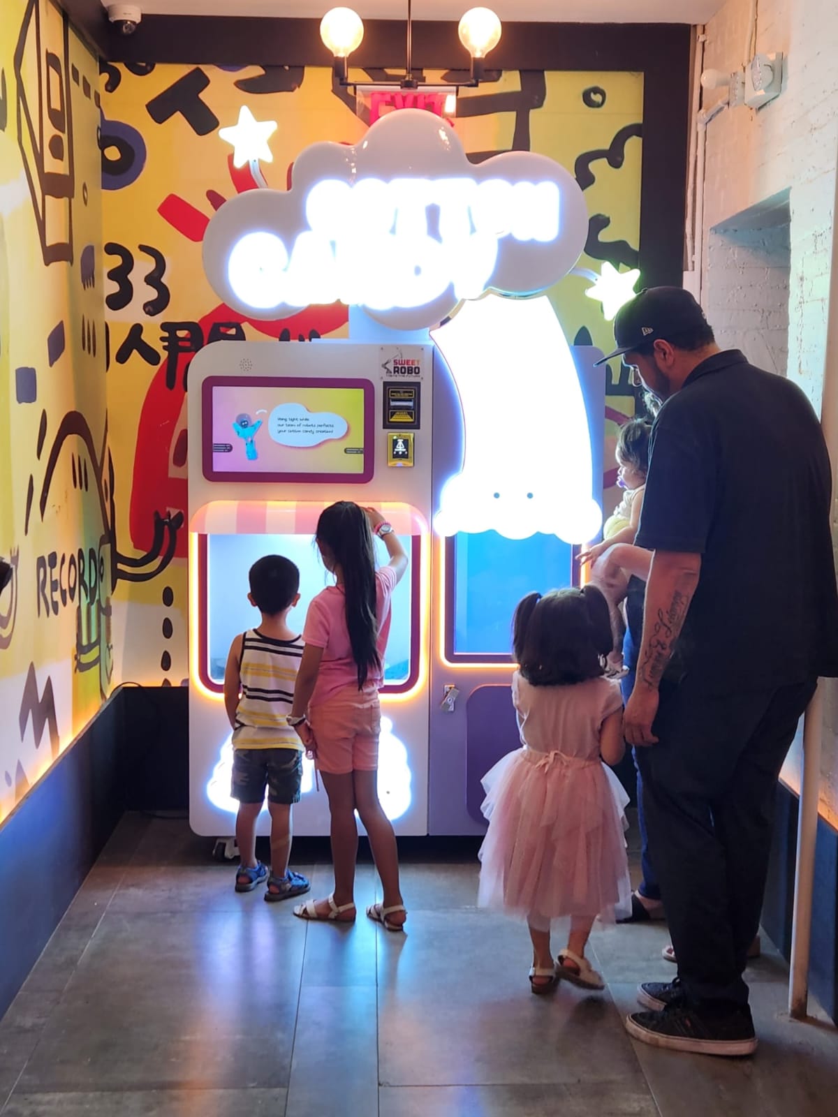 Family enjoying cotton candy machine together